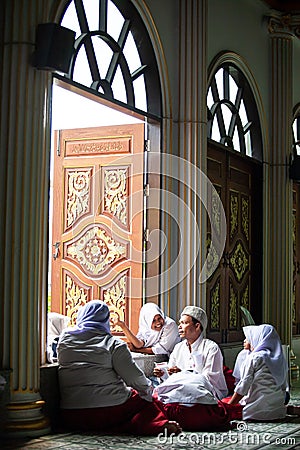 Happy lovely muslim young girls in traditional clothing with male muslim teacher inside the mosque. Nong Chok, Bangkok, Thailand Editorial Stock Photo